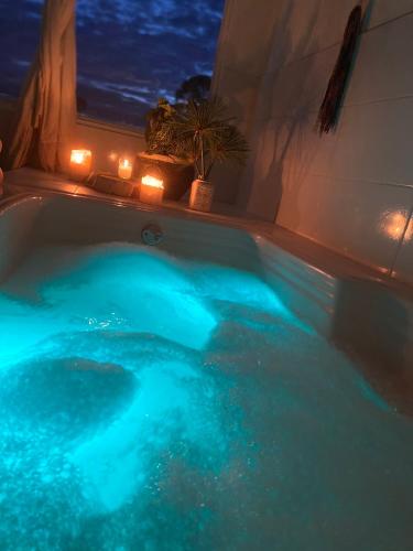 a bath tub with blue lighting in a room at La Madriguera in Guatapé
