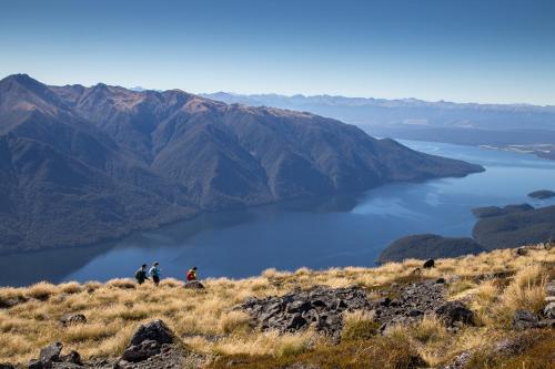 a group of people standing on a hill overlooking a lake at Fiordland Lodge in Te Anau