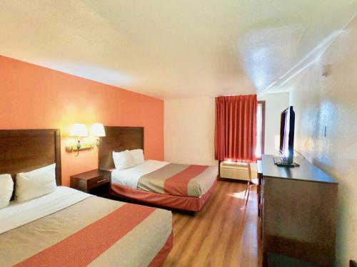 a hotel room with two beds and a television at Motel 6-Levittown, PA - Bensalem in Levittown