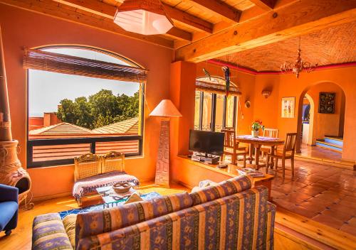 a living room with a couch and a large window at Casa Estrella de la Valenciana Hotel Boutique in Guanajuato