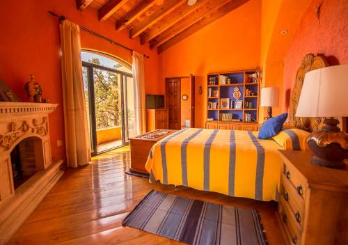 a bedroom with a bed and a fireplace at Casa Estrella de la Valenciana Hotel Boutique in Guanajuato