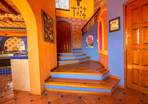 a hallway of a house with stairs and a door at Casa Estrella de la Valenciana Hotel Boutique in Guanajuato
