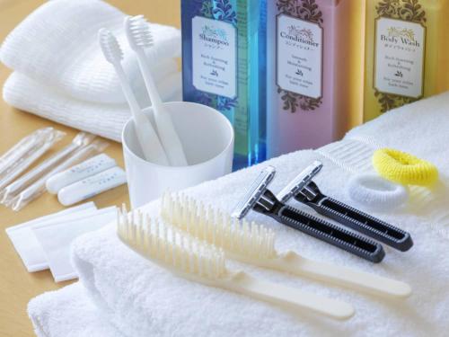 a group of toothbrushes and towels on a table at Hotel Sapporo Garden Palace in Sapporo