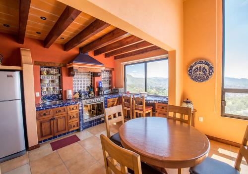 a kitchen with a wooden table and a dining room at Casa Estrella de la Valenciana Hotel Boutique in Guanajuato