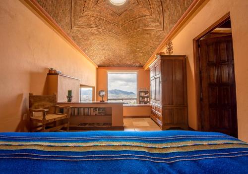 a bedroom with a large bed and a large window at Casa Estrella de la Valenciana Hotel Boutique in Guanajuato
