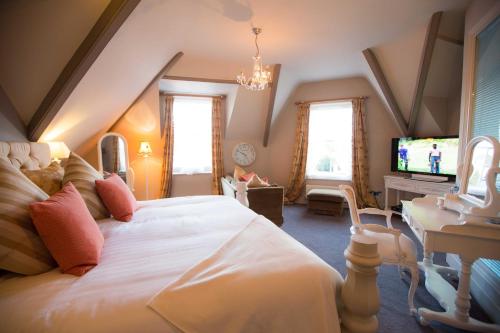 a bedroom with a large bed and a tv at OX Hotel, Bar, & Grill in Poole