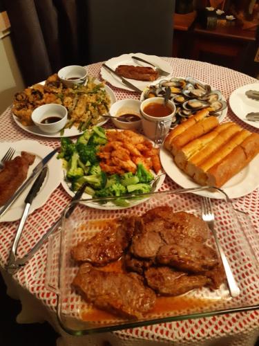 a table with many plates of food on it at rooms with a view in Haywards