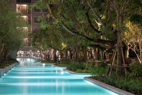 a swimming pool with trees in a building at La Casita Hua Hin Pool and Garden View in Hua Hin