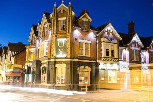 a building with a clock on the side of it at OX Hotel, Bar, & Grill in Poole