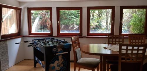 a kitchen with a stove and a table and windows at Haus Daniel Mariazell in Mariazell