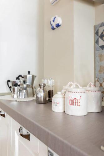 a kitchen counter with pots and pans on it at Casa Aydée in Bergamo
