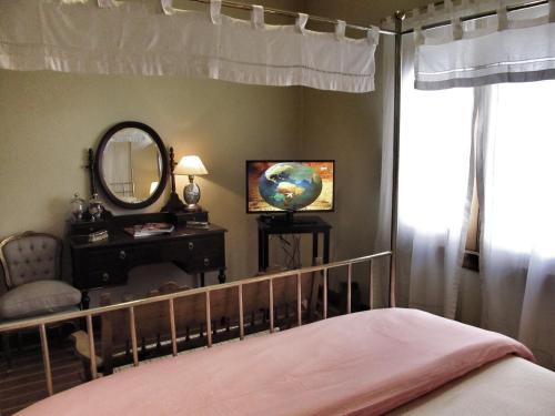 a bedroom with a bed and a mirror and a chair at Solar De La Plaza in Salta