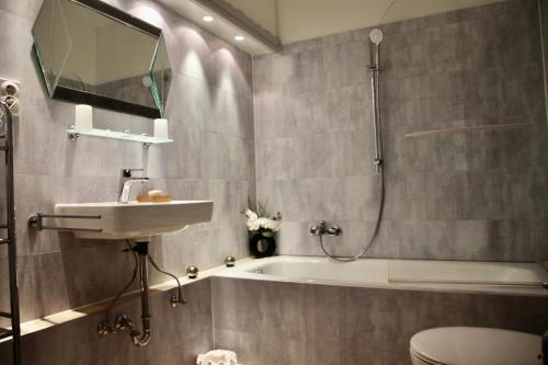 a bathroom with a sink and a tub and a shower at Appartement Scharf in Bad Harzburg