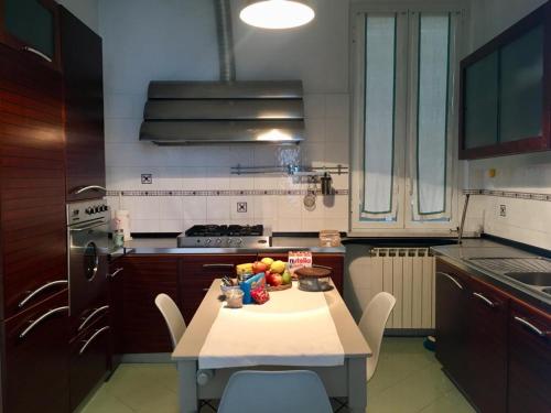 a kitchen with a table with a bowl of fruit on it at Relax in Darsena - Savona in Savona
