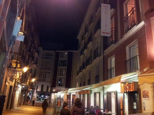 a city street filled with lots of tall buildings at Hostal riMboMbin in Burgos