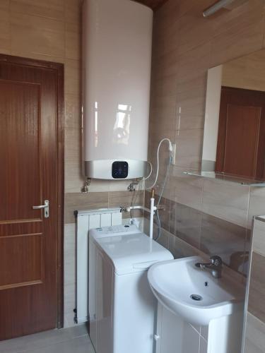 a bathroom with a white sink and a toilet at Galamb Villa in Siófok
