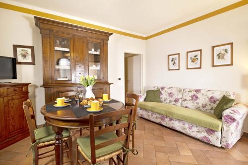 a living room with a table and a couch at Borgo Grondaie in Siena