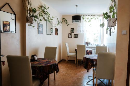 a dining room with tables and chairs and a window at Hotel Marko in Przemyśl