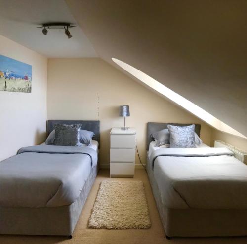 two beds in a room with a attic at South Beach Apartment in Ardrossan
