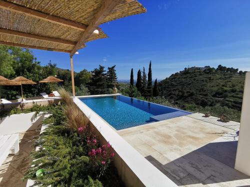 a swimming pool in a villa with a view at Casa Del Mandorlo in Noto