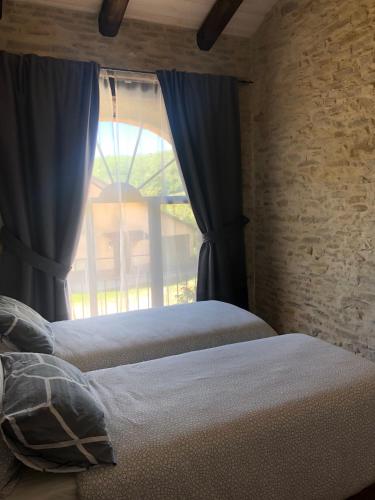 a bedroom with a bed and a window at Cà Tinola in Mango