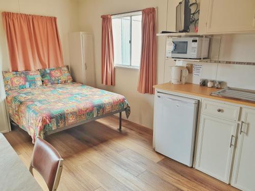 a small kitchen with a bed in a room at Skytrek Willow Springs Station in Flinders Ranges