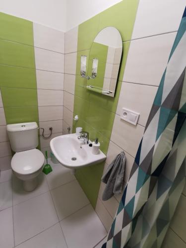 a bathroom with a toilet and a sink at Penzión Bernáth in Rožňava