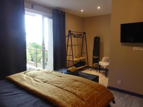 a bedroom with a bed and a large window at Casa Peppina - Chez Tonio et Sylvie in Sari Solenzara