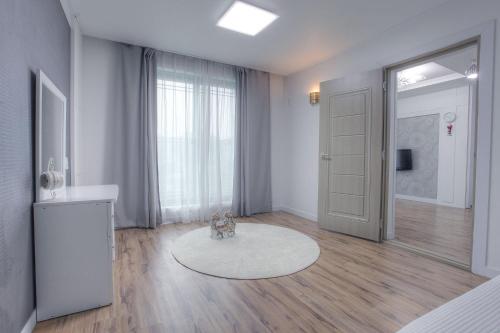 a living room with a door and a teddy bear on a rug at Forest of Color Pension in Hongcheon