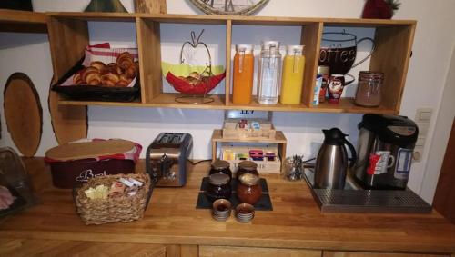 a kitchen counter with a coffee maker and food on it at Pension Bergseeblick in Titisee-Neustadt