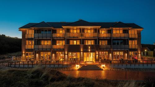 a large building with lights in front of it at Die Sandburg in Langeoog