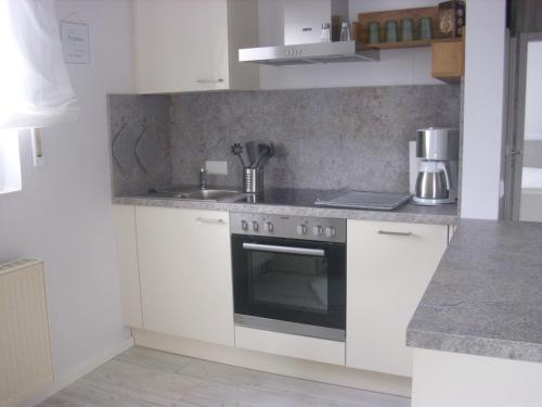 a kitchen with a stove and a sink at Haus Mühlenbach in Mechernich