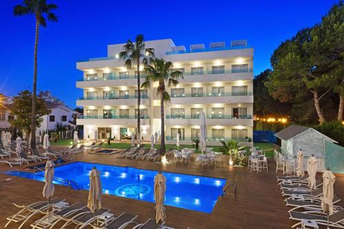 a hotel with a swimming pool in front of a building at Metropolitan Juka Playa in Playa de Palma