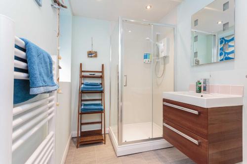 a bathroom with a shower and a sink at Beach Cottage in Lytham St Annes