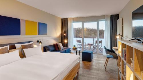 a hotel room with a bed and a living room at Die Sandburg in Langeoog