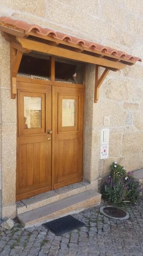 a wooden door on the side of a building at Olhares do Douro "A casa do Avô Zé" in Torre de Moncorvo