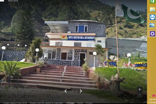 a building with stairs in front of a building at Hotel Shelton Inn in Batkarar