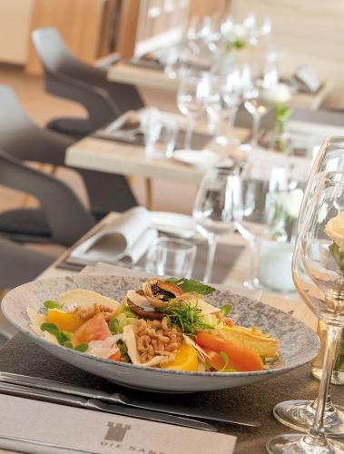 a plate of food on a table in a restaurant at Die Sandburg in Langeoog