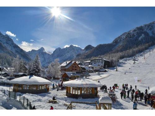 a group of people on a ski slope in the snow at Vila Mojca Apartma Eva-Neža, Kranjska Gora (center) in Kranjska Gora
