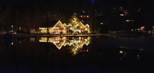 a house with a christmas tree is lit up at night at Vila Mojca Apartma Eva-Neža, Kranjska Gora (center) in Kranjska Gora