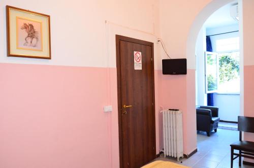 a door in a room with a pink wall at Hotel New Milan in Milan