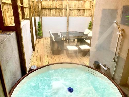 a jacuzzi tub in the middle of a patio at Victory hot tub house in Blackpool