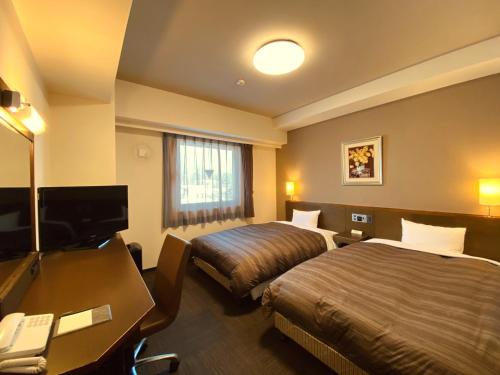 Postel nebo postele na pokoji v ubytování Hotel Route-Inn Ina Inter