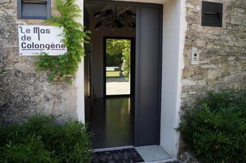 a door to a building with a sign on it at le mas de colongene in Faucon