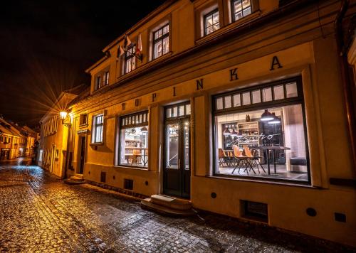a building with windows on a street at night at Ultra premium apartments in Český Krumlov