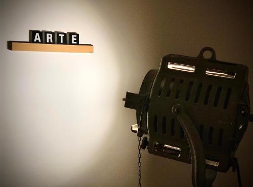 a black object on a wall next to a light at B&B Arts And Music in Ancona