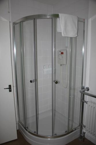 a shower with a glass door in a bathroom at Cadame in Whitby