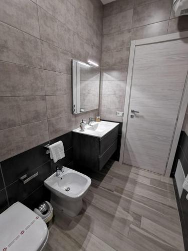 a bathroom with a sink and a toilet and a mirror at B&B La Casa di Pino in Lampedusa