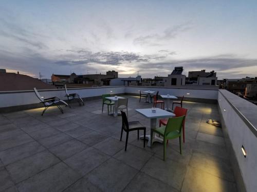 a patio with tables and chairs on a roof at B&B La Casa di Pino in Lampedusa