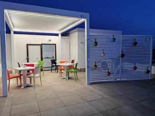 a room with tables and chairs and a blue wall at B&B La Casa di Pino in Lampedusa